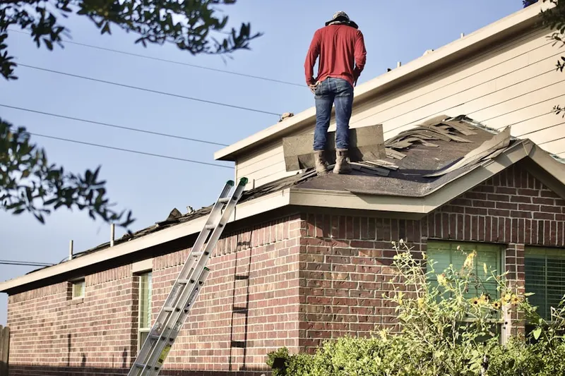 Professional roofer working on a residential roof in New Waverly